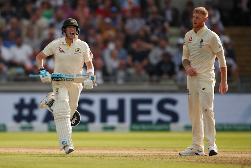 A helmeted batsman roars in triumph as he runs past a dejected bowler to reach his Test century.