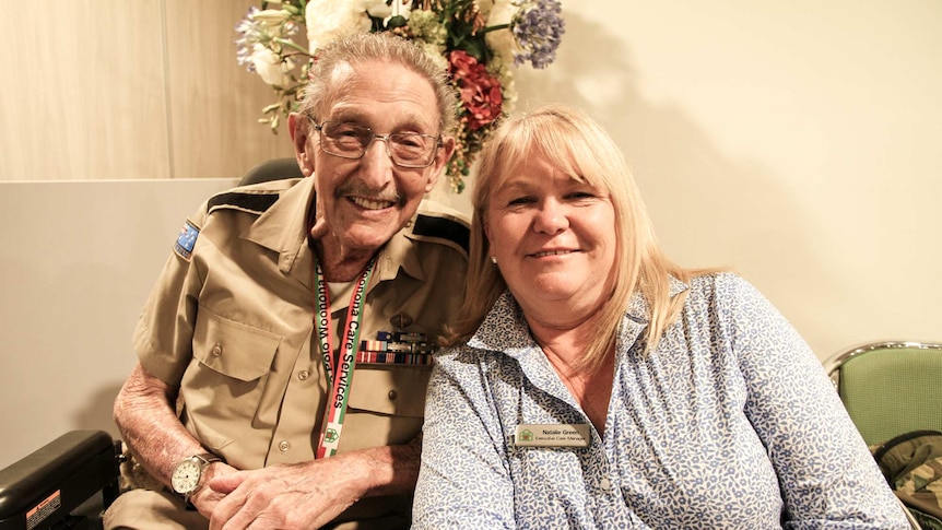 The executive care manager sits with a resident