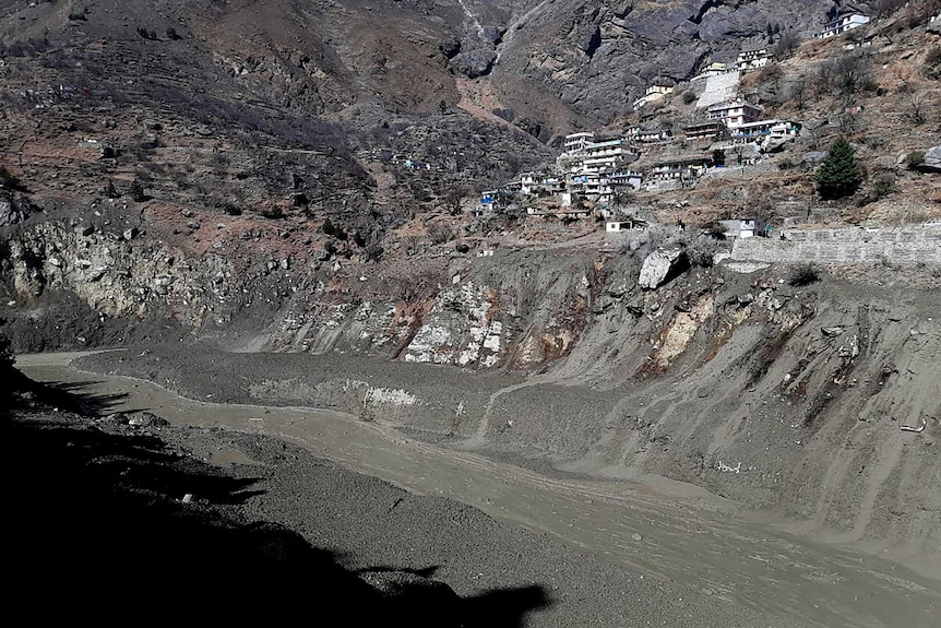 Mud coats the steep banks of a river