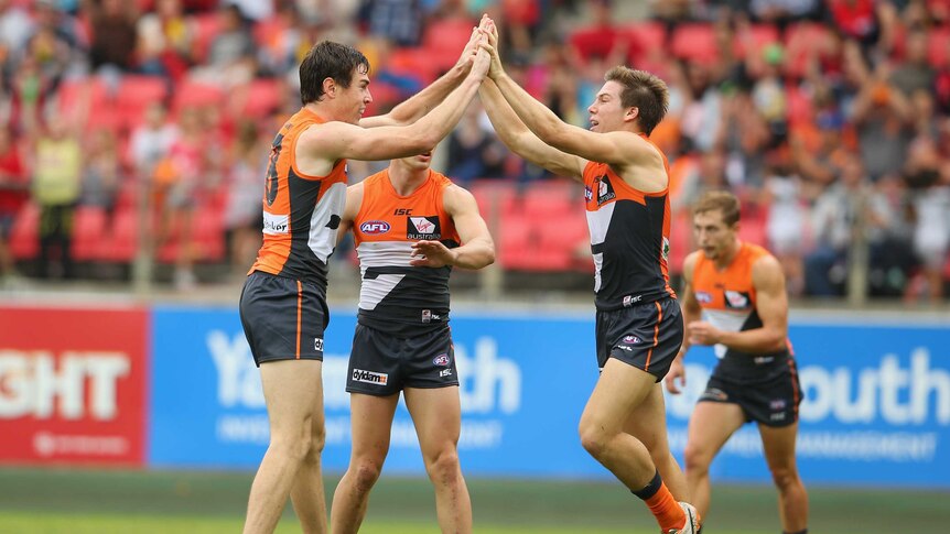 Jeremy Cameron celebrates with Toby Greene after kicking a goal for GWS against Melbourne