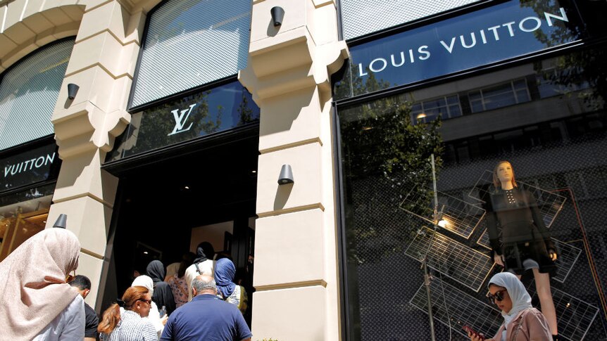 Workers place the damage in the Louis Vuitton store in Barcelona's