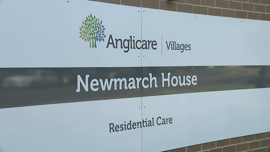 An outdoor sign on the wall staying Newmarch House.