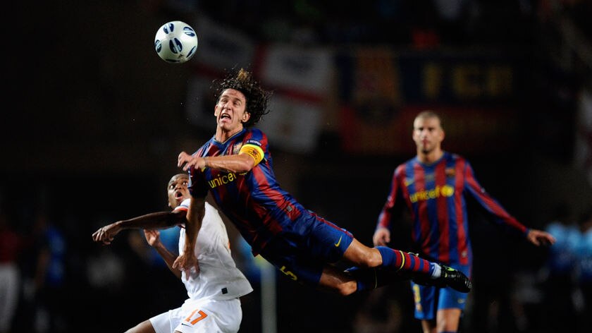 Puyol battles with Adriano