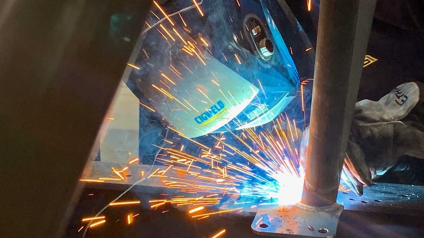 A welder working with sparks flying at AGI in Sydney.