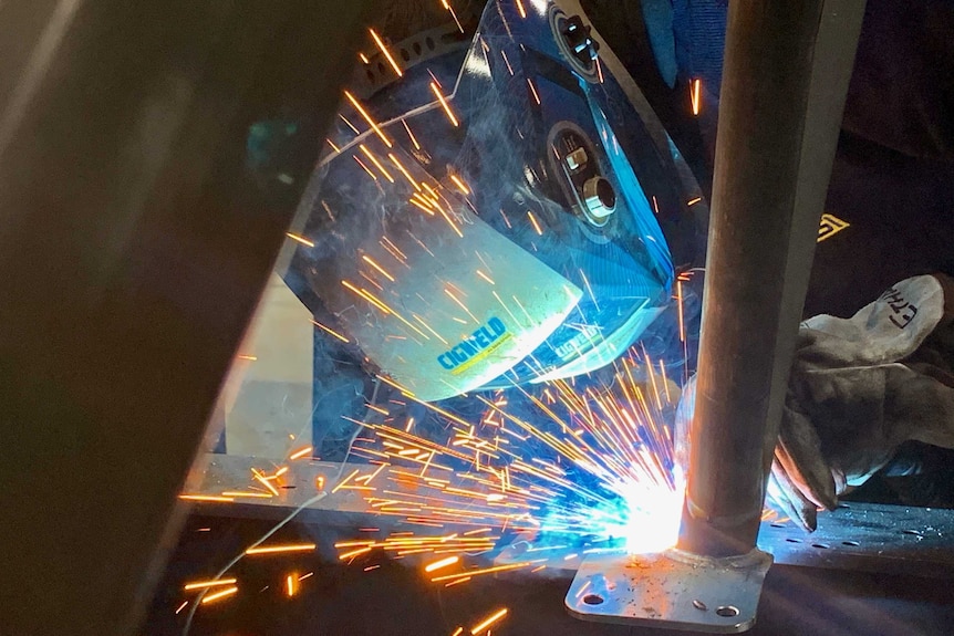 A welder working with sparks flying at AGI in Sydney.