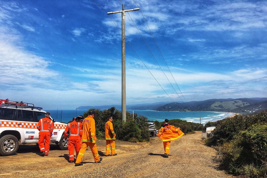 Emergency service crews walk towards the beach in the search for missing Melbourne woman Elisa Curry at Aireys Inlet