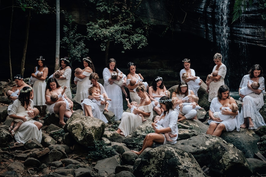 A group of women photographed breastfeeding their children