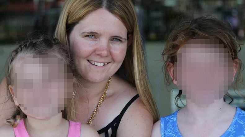 A lady pictured with two children, their faces blurred out.