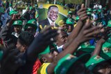 Supporters of Ruling party ZANU-PF at election rally hold a poster of Zimbabwean President Emmerson Mnangagwa