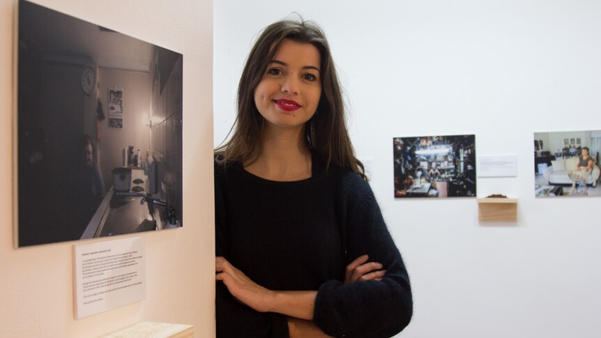 Eleni Christou with her photos in the Chrissie Cotter Gallery