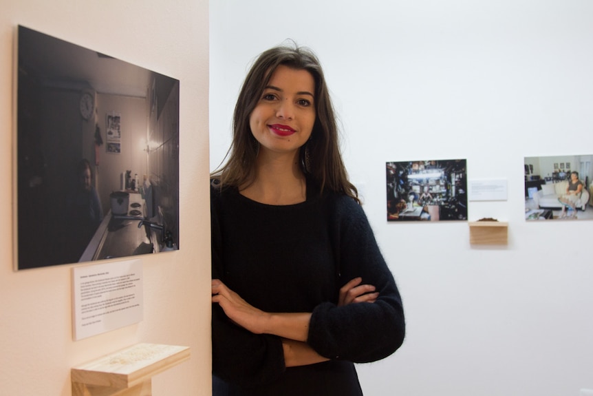 Eleni Christou with her photos in the Chrissie Cotter Gallery