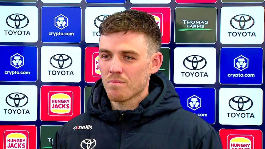 A football player at a media conference.