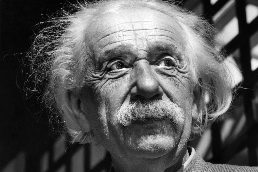 A close up black and white photo of Albert Einstein