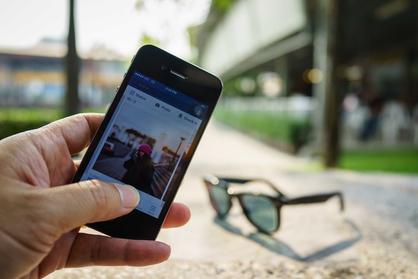 A smartphone screen with a Facebook feed.