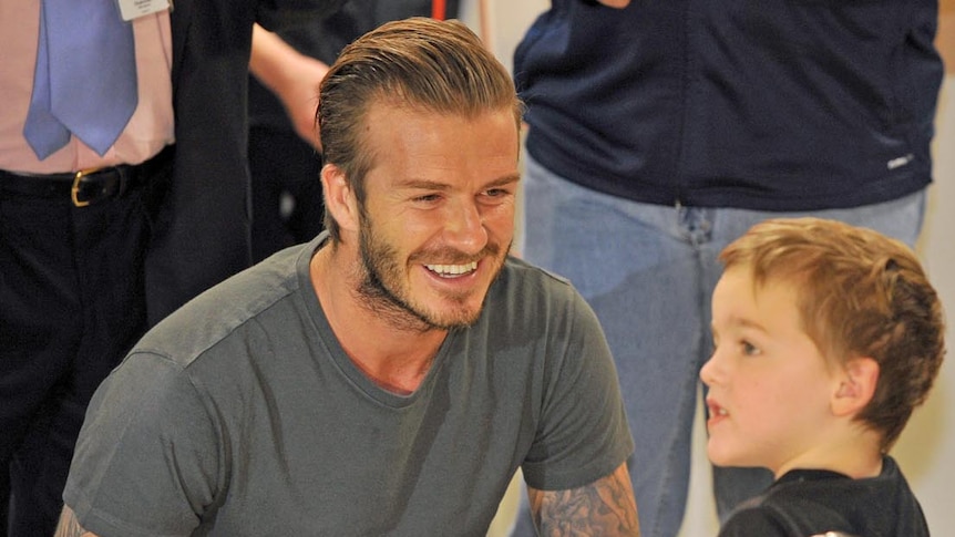 David Beckham speaks with four-year-old patient Dean van Wyk.