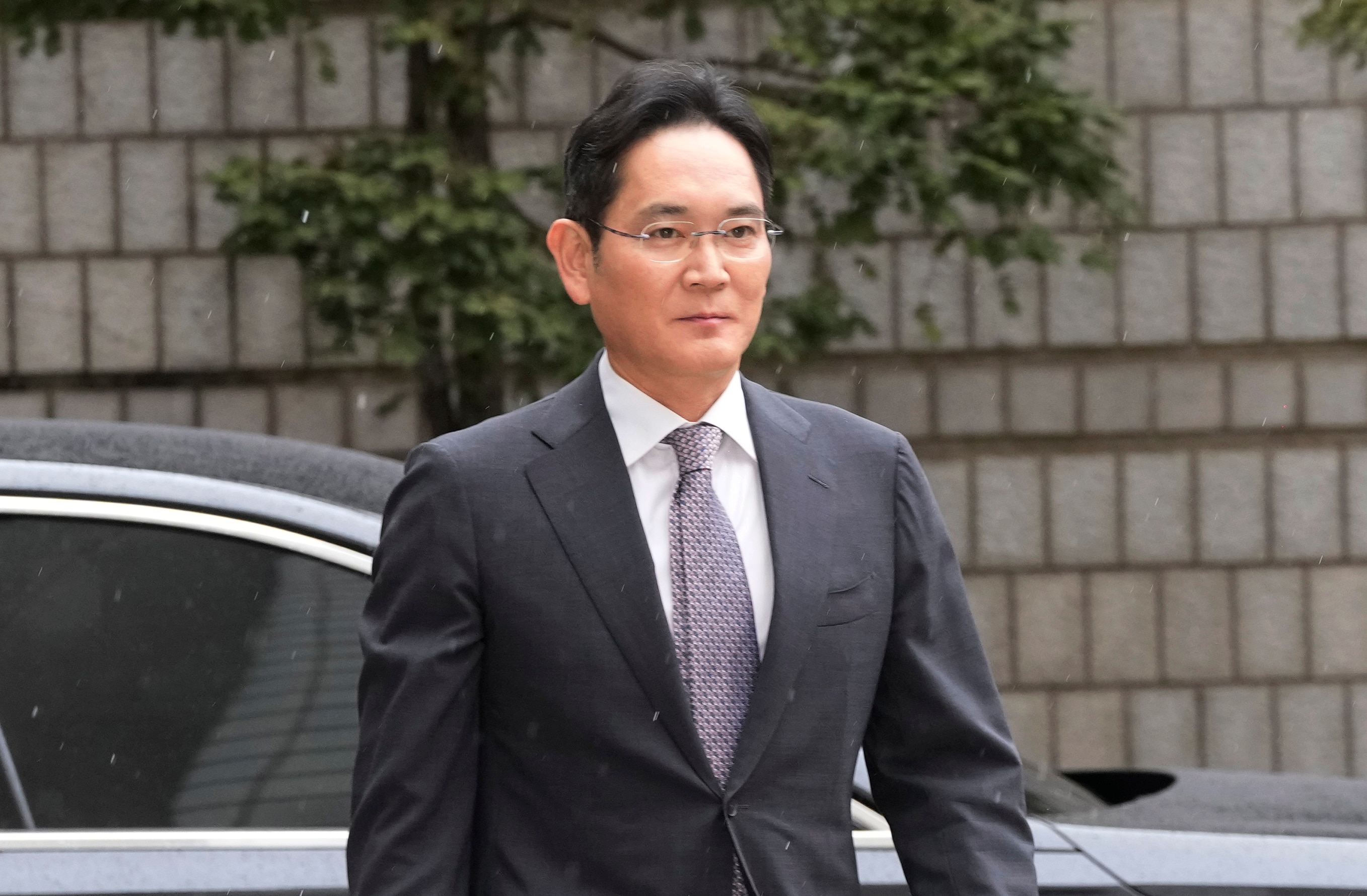 A man with glasses wearing a suit.