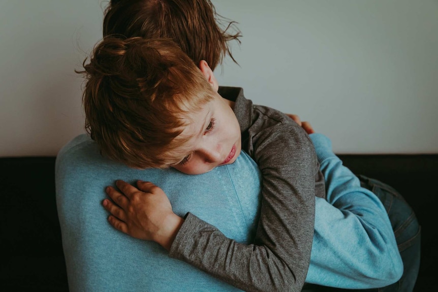 Father comforting sad child.