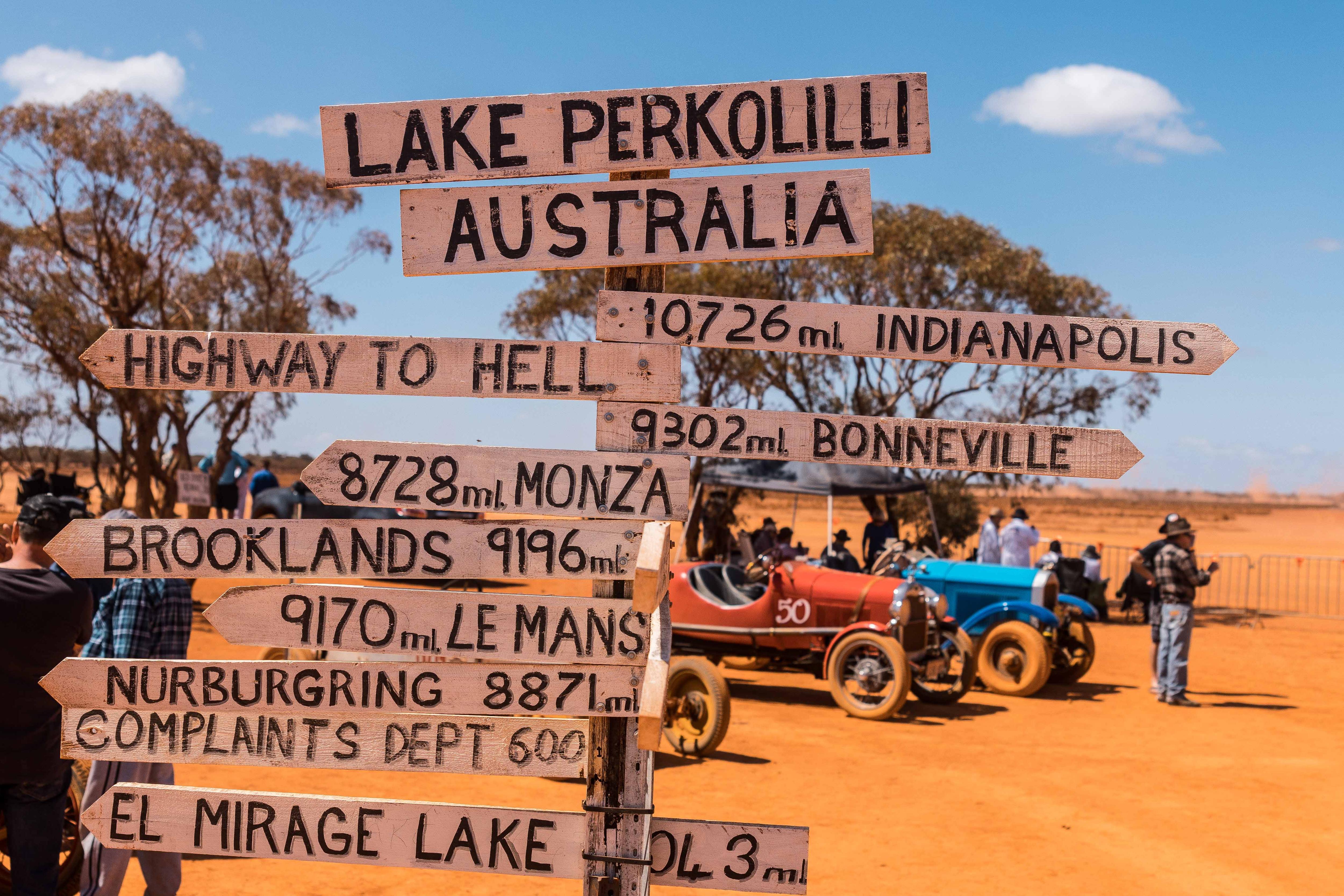 A joke traffic sign pointing to other famous race tracks around the world.   
