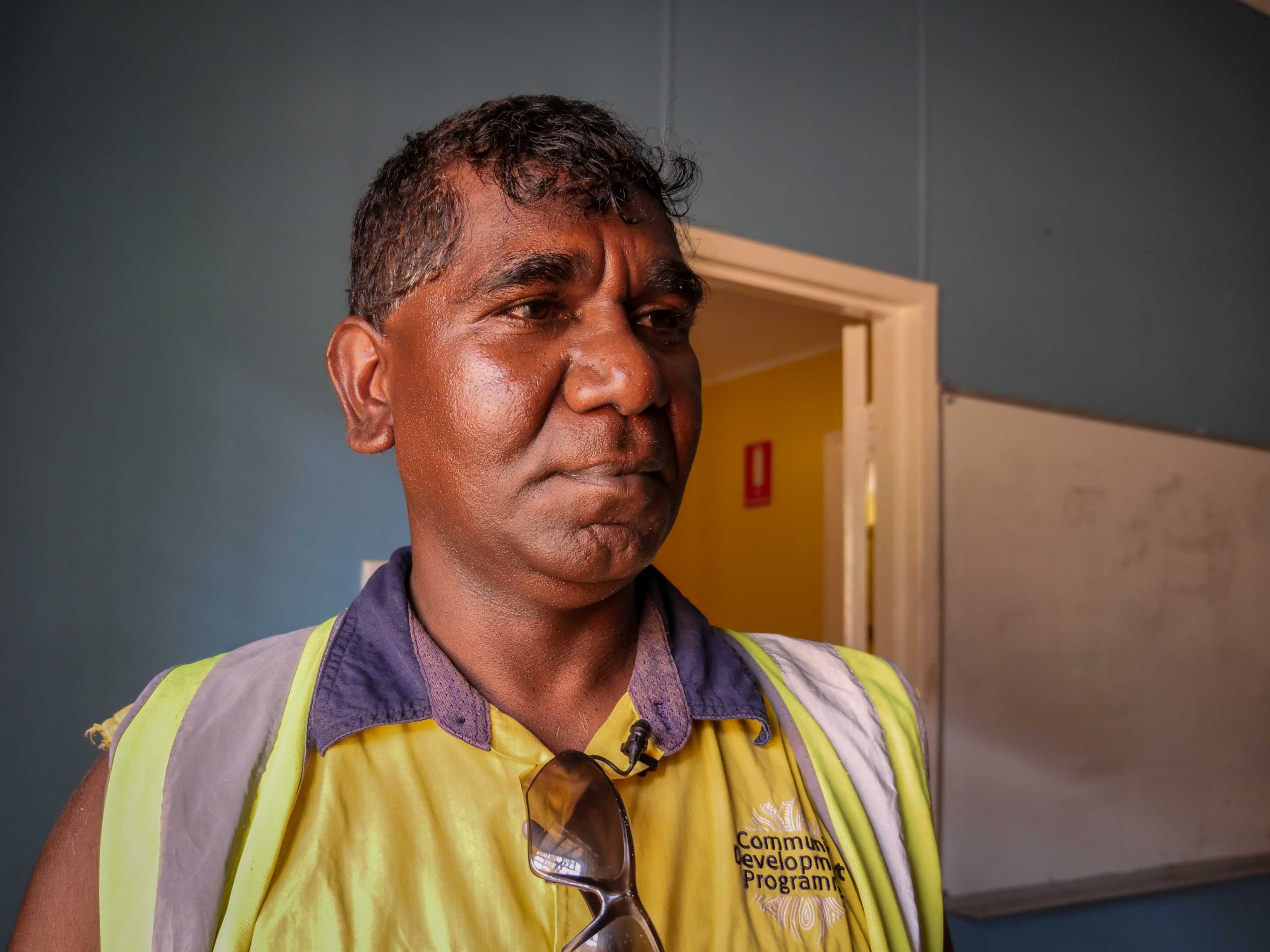 A mid shot of Shannon Killer from Looma posing for a photo indoors in hi-vis clothing.