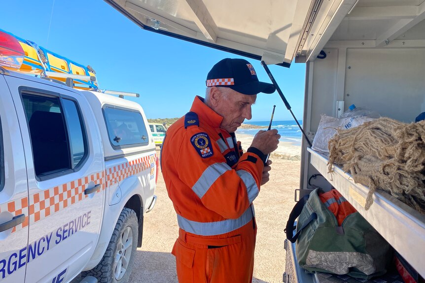 A State Emergency Service rescuer at the site of a search for a missing surfer.