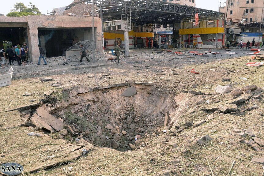 Large crater after blasts tear through Aleppo