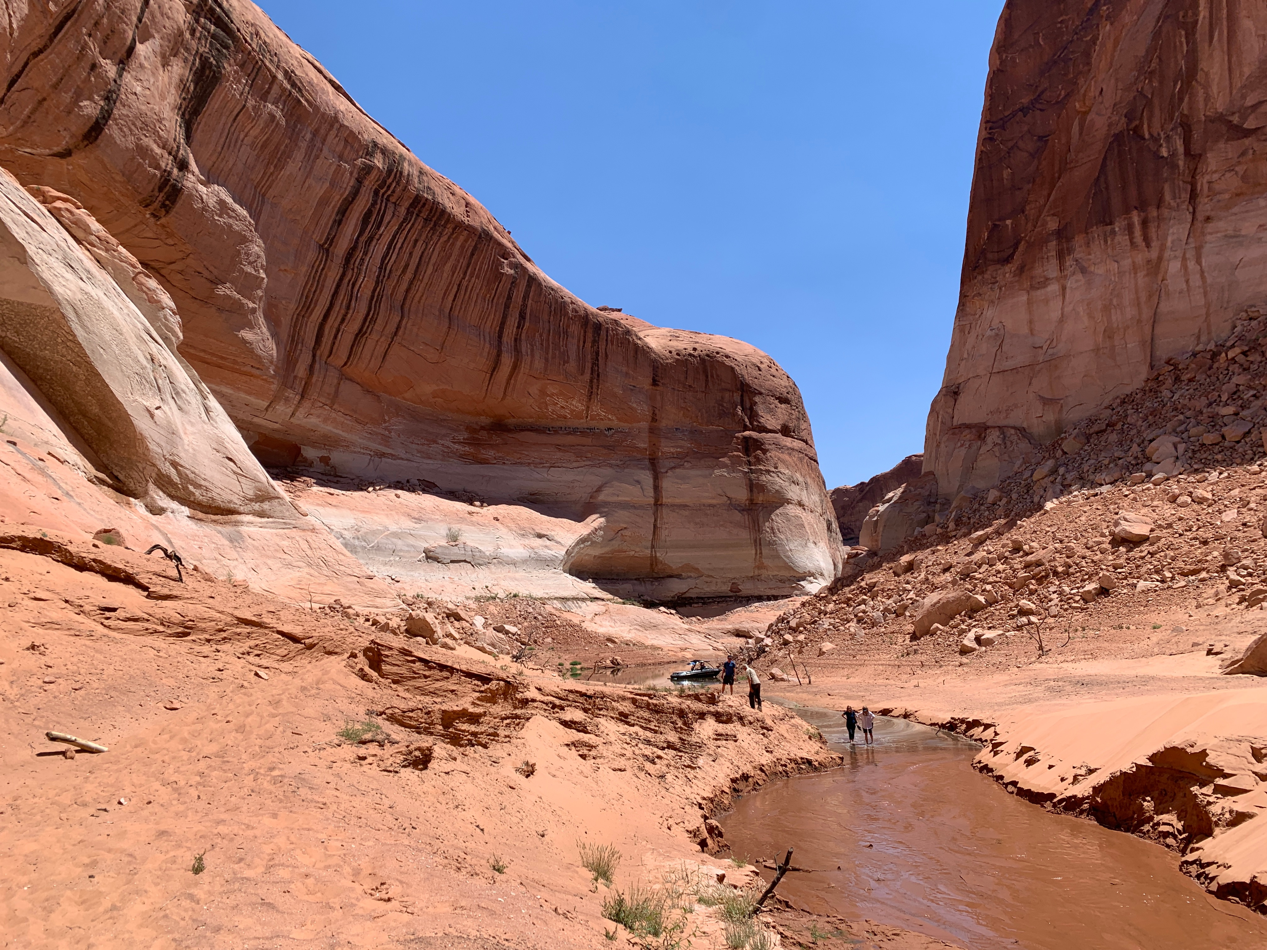 People walking up a stream.