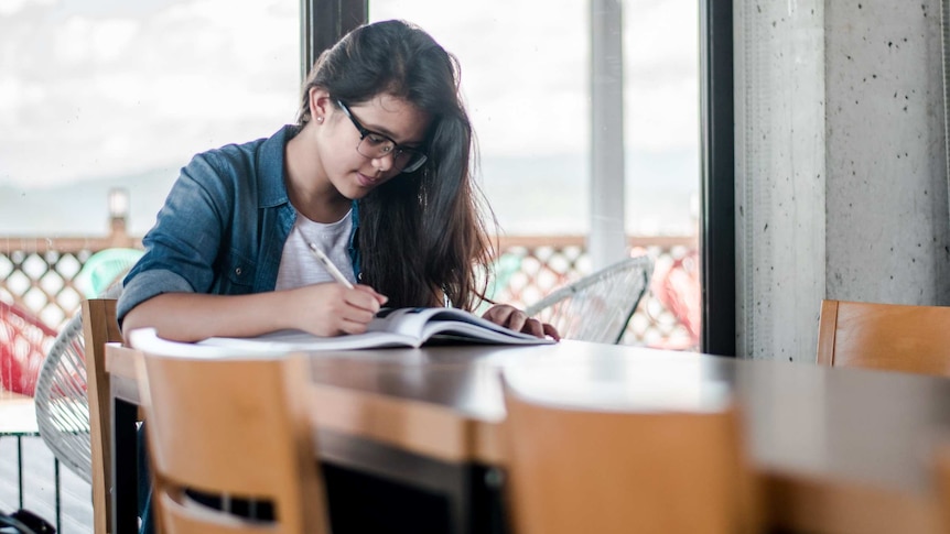 Student studying for a story about parent/teacher interviews.