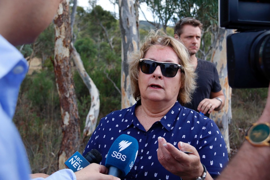 A distressed resident speaks to the media.