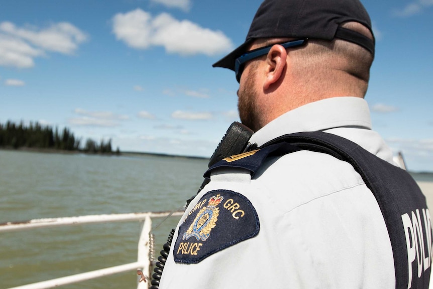 A police officer looking at a river