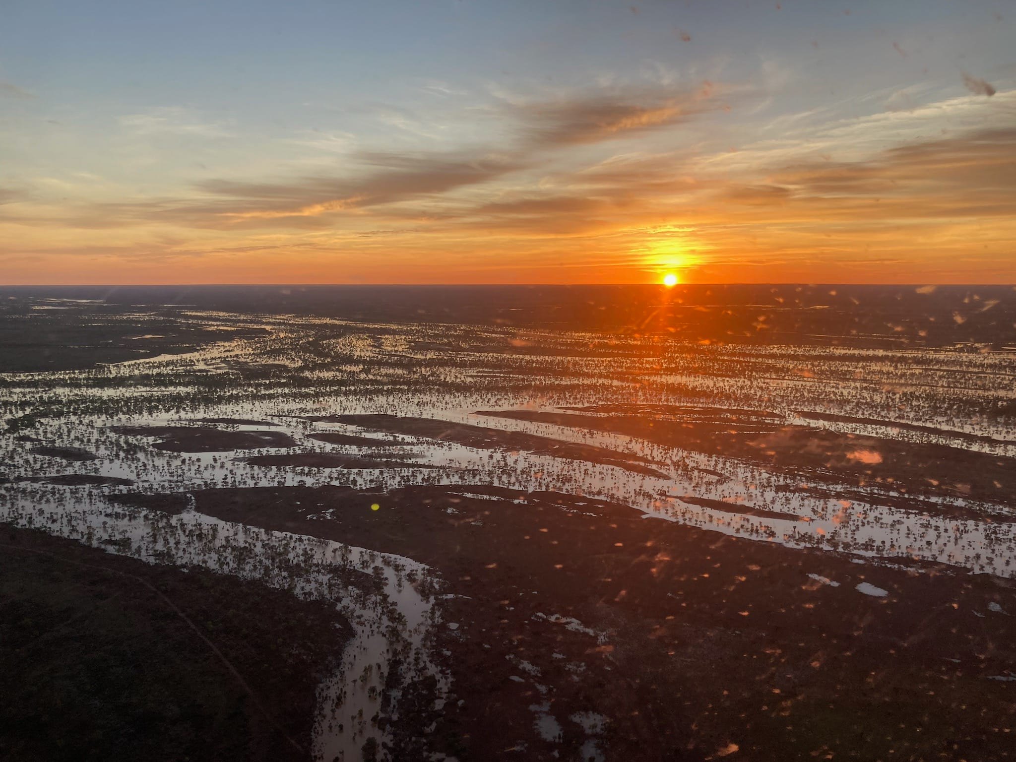 The sun rises over flooded channels in outback Queensland.