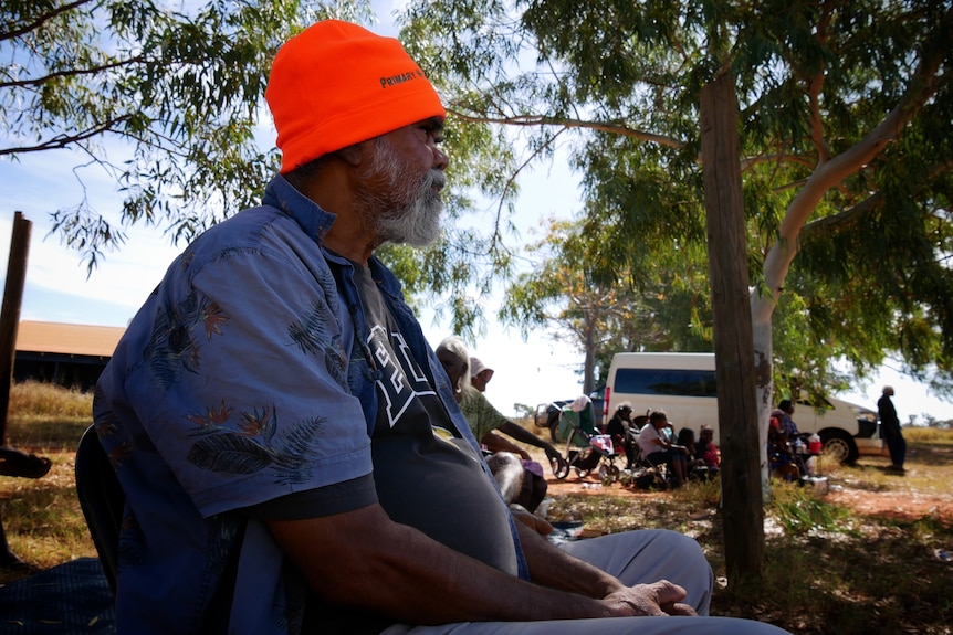 Bidyadanga elder Joseph Munroe watching football June 2022. 