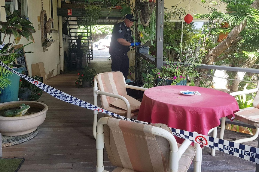Police officer investigates a crime scene in a taped-off area of restaurant at Point Vernon
