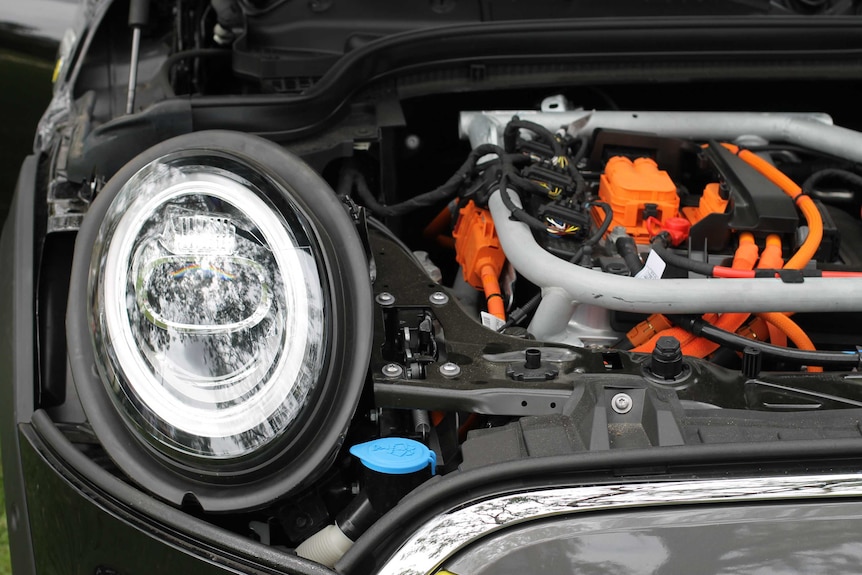 A picture of a motor in an electric vehicle with the bonnet lifted.