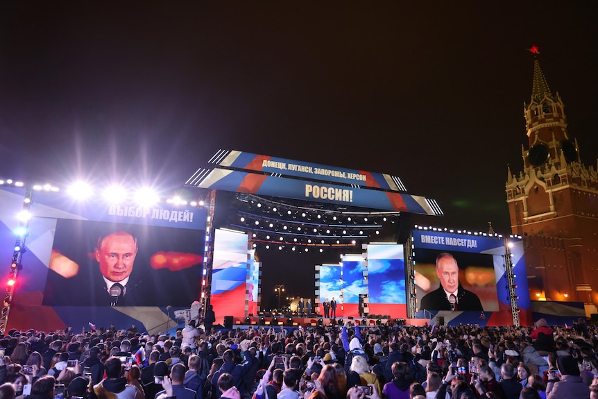 Spectators listen to Russian President Vladimir Putin during a concert in Moscow's Red Square.