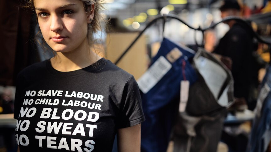 A woman wears a t-shirt reading 'no blood, no sweat, no tears' at Fashion Week Berlin.