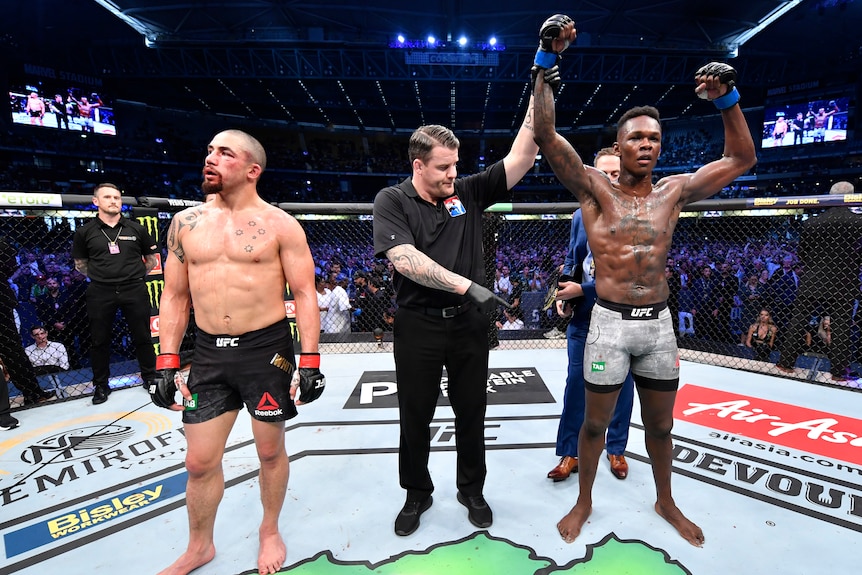 UFC fighter Israel Adesanya celebrates after his knockout victory over Robert Whittaker 