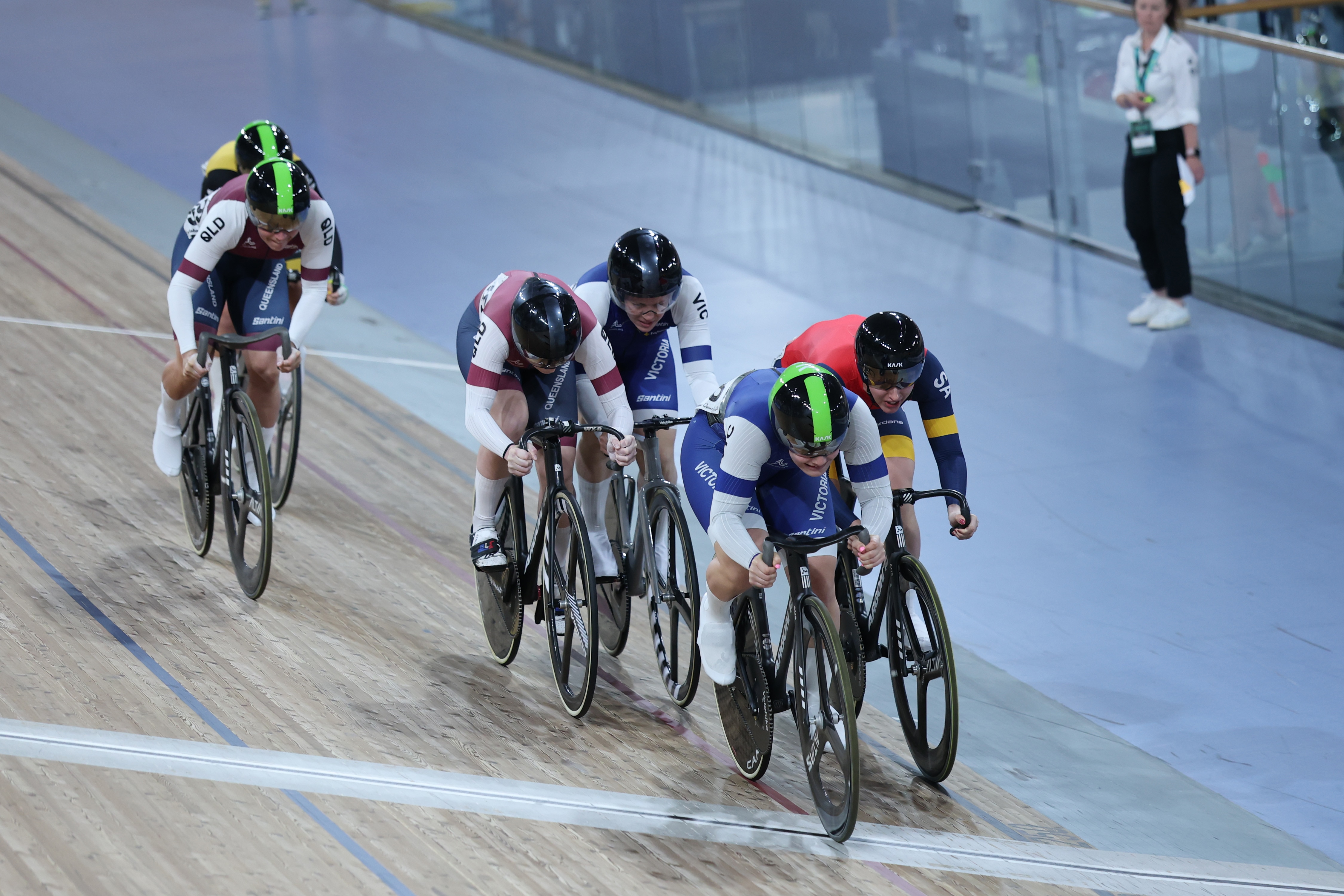 The keirin racers jostle for position on a velodrome track