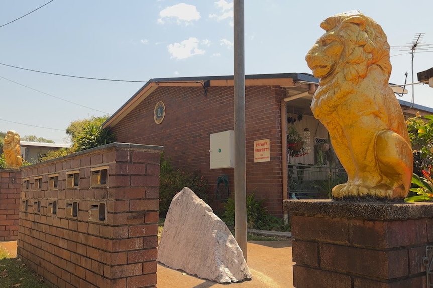 Photo of front of unit complex with statues of golden lions at entrance