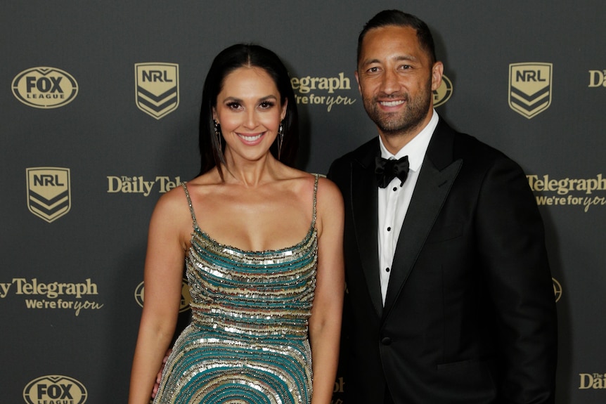 An NRL player stands with his wife on the red carpet at the 2019 Dally M Awards.