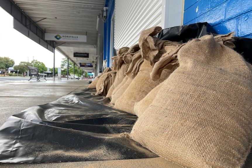 sandbags along the ground in front of shops