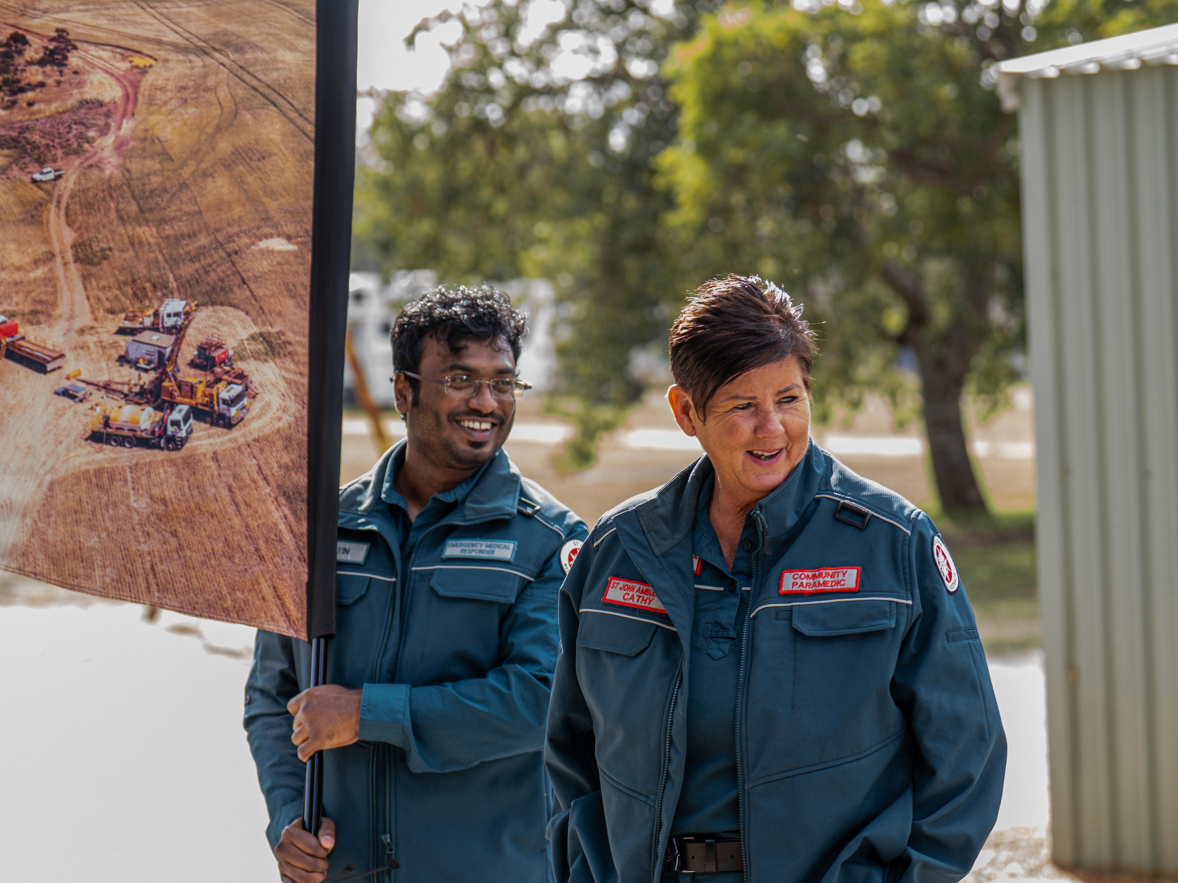 A man and women in St John ambulance uniforms smiling