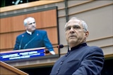 Jose Ramos-Horta stands in front of a microphone