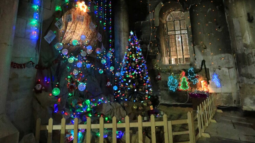 A Christmas display lights up a corner of the Immaculate Conception church in Mosul.