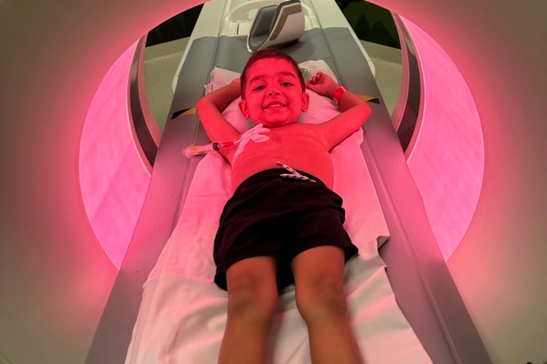 A boy on a CT machine.