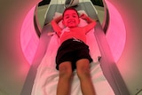 A boy on a CT machine.
