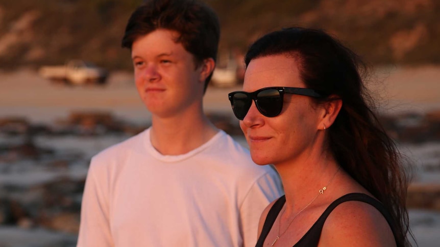 Haley Allan and her son on a beach in Broome