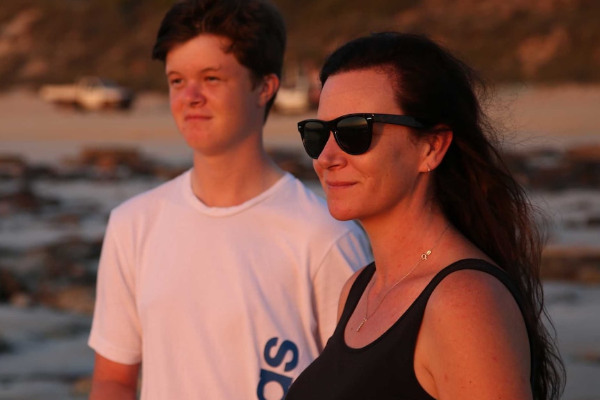 Haley Allan and her son on a beach in Broome