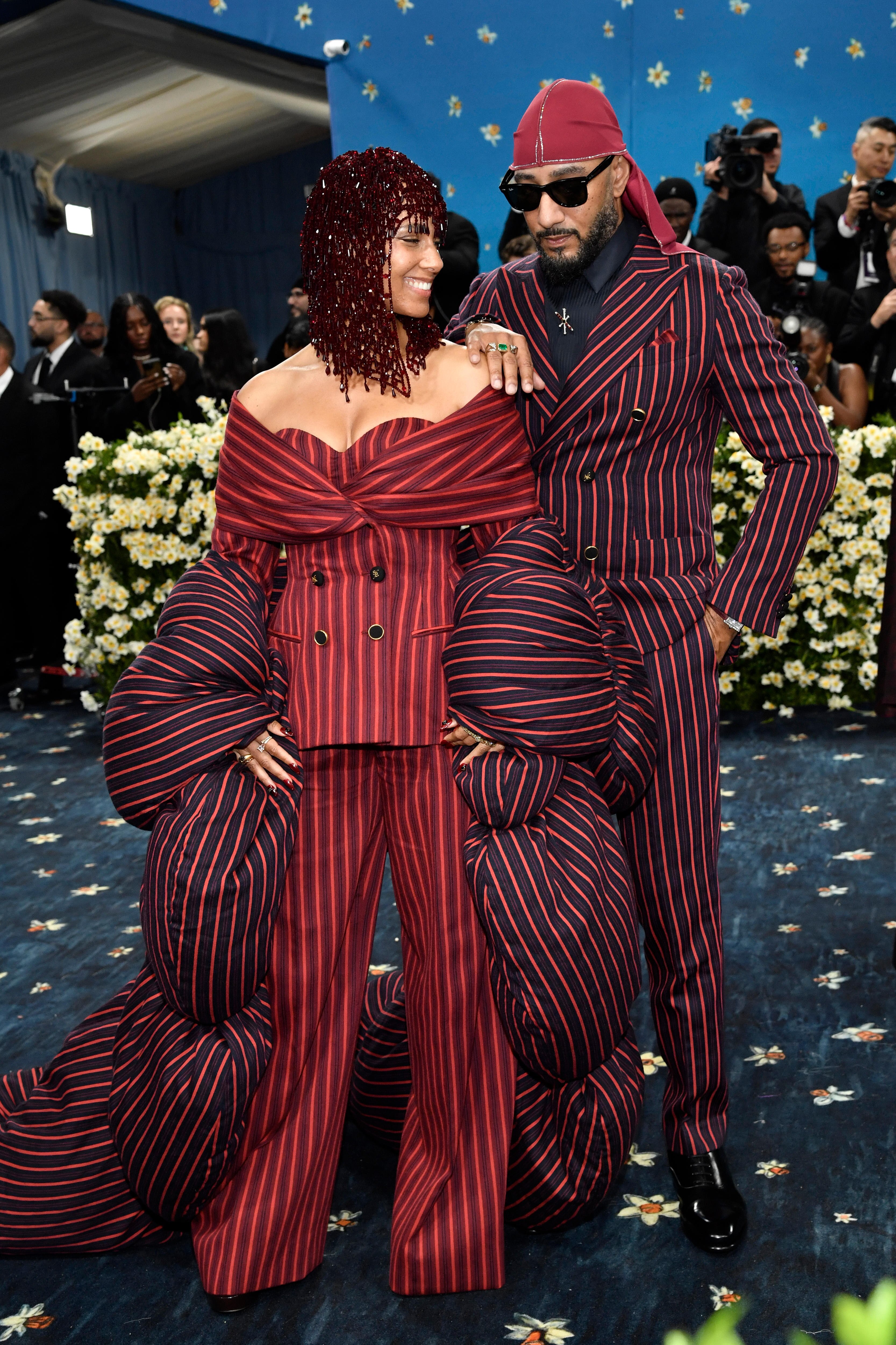 Alicia Keys and Swizz Beatz in matching maroon and red pinstriped suits