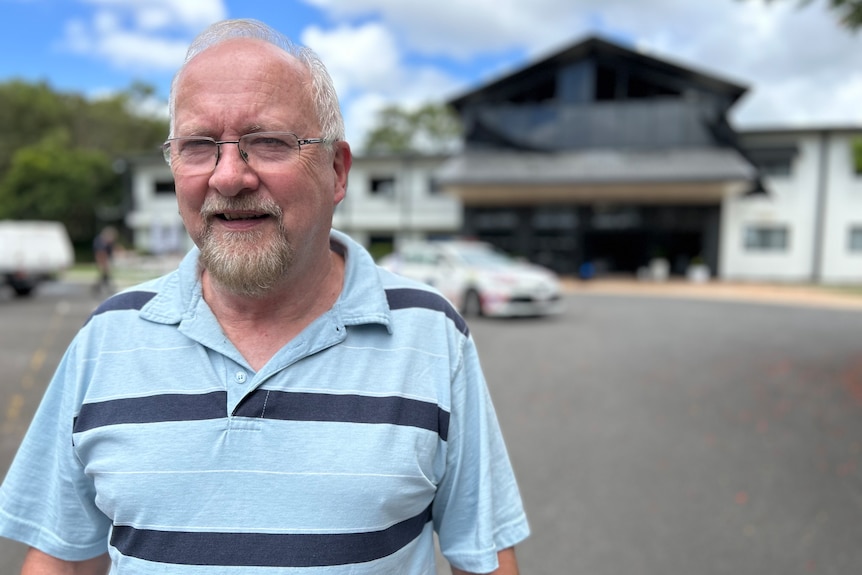 Pastor Phil Greenbury looking at the camera standing outside his church. 