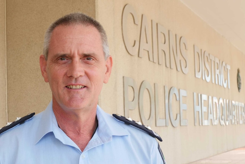 Man in police uniform standing outside Cairns District Police Headquarters